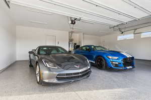 Garage with baseboards and gas water heater