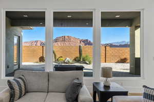 Living area with a mountain view, healthy amount of natural light, and wood finished floors