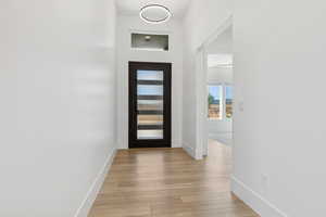 Foyer featuring baseboards and light wood-style flooring