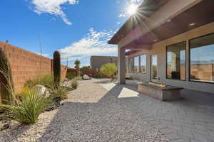 Fenced backyard with a patio and an outdoor fire pit