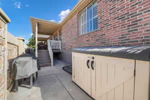 View of patio featuring grilling area and stairway