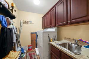 Laundry room featuring cabinet space and independent washer and dryer