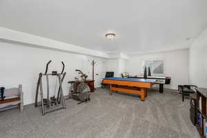 Recreation room with light colored carpet and baseboards