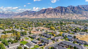 Aerial view of property and surrounding area with nearby suburban area