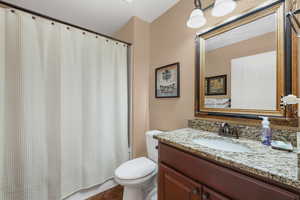 Full bathroom featuring shower / bath combo and vanity
