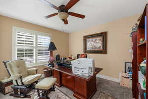Office space featuring ceiling fan and carpet flooring