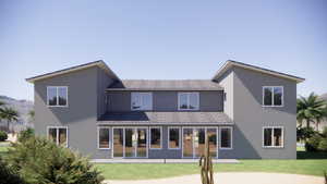 Back of property with stucco siding and a yard