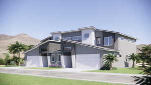 Contemporary home featuring a mountain view, stucco siding, a front yard, and brick siding
