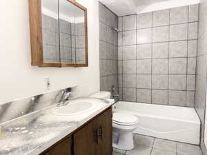 Bathroom featuring vanity,  shower combination, and light tile patterned floors