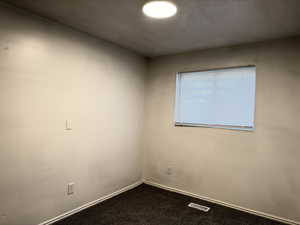 Spare room with carpet and baseboards