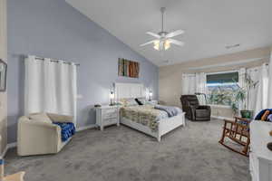 Carpeted bedroom featuring high vaulted ceiling and ceiling fan