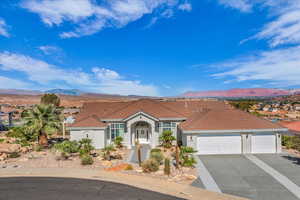 Mediterranean / spanish house featuring a garage, a mountain view, driveway, and a tiled roof