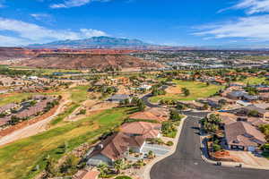 Aerial perspective of suburban area with mountains and a golf course