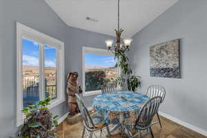 Dining space with a chandelier and lofted ceiling