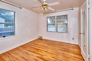 Unfurnished room featuring light wood finished floors and ceiling fan