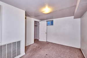 Unfurnished bedroom with carpet floors and a textured ceiling