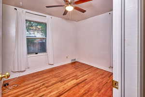 Unfurnished room with light wood-style floors and ceiling fan