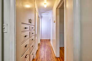 Hall featuring light wood finished floors and attic access