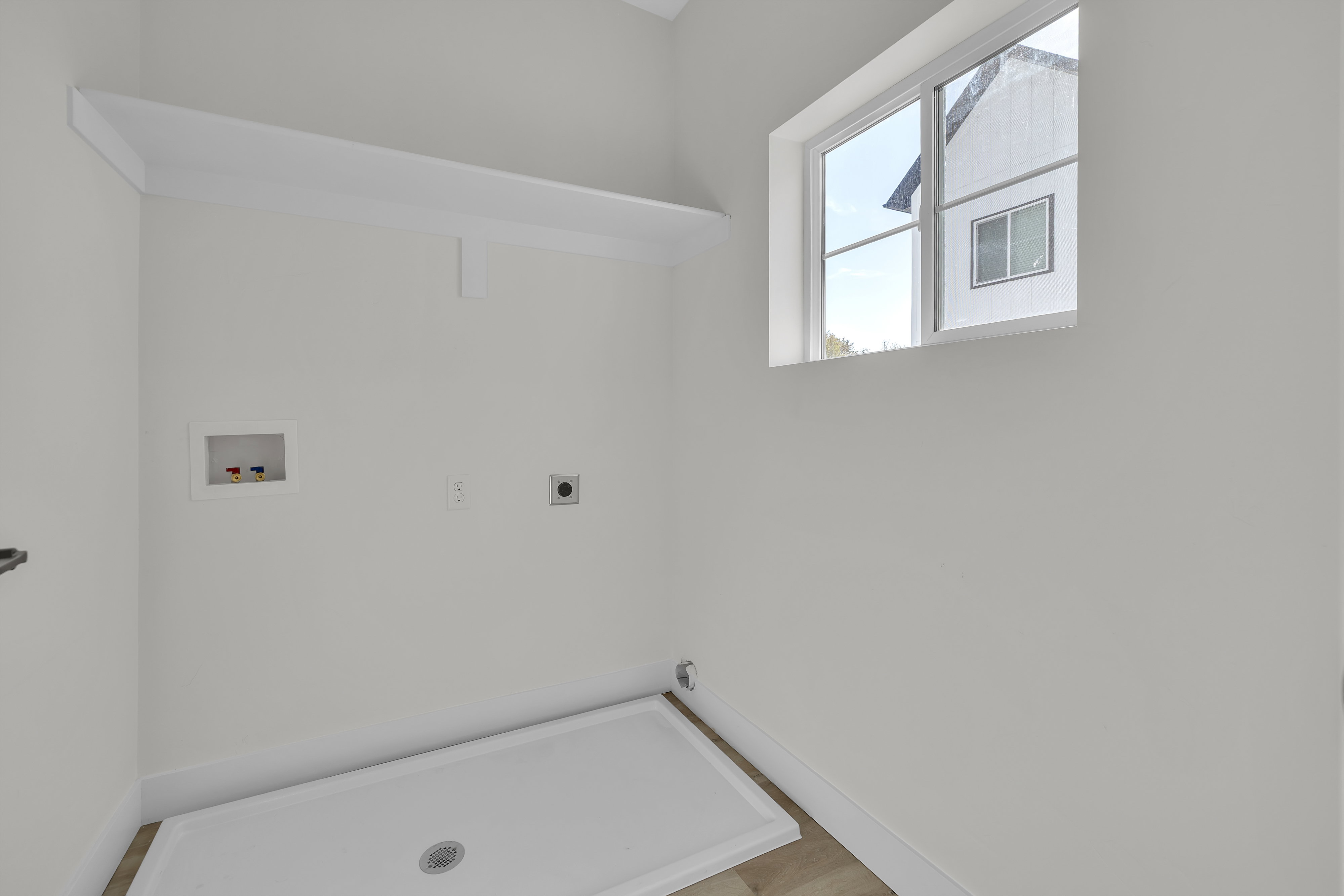 Washroom featuring hookup for a washing machine and electric dryer hookup