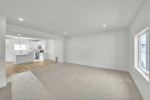 Living room featuring light carpet and recessed lighting