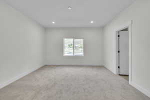 Master Bedroom featuring light carpet and recessed lighting