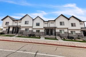 Modern inspired farmhouse with board and batten siding and stone siding