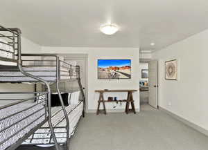 Bedroom with light carpet and baseboards