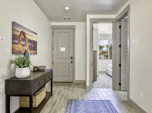 Entrance foyer with wood finish floors and baseboards