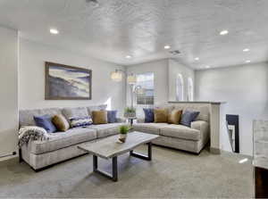 Living area with carpet floors and recessed lighting