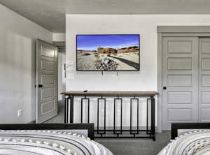 Carpeted bedroom featuring a closet
