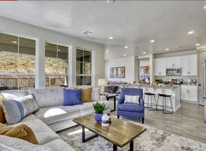 Living room with wood tiled floors, recessed lighting, and a textured ceiling