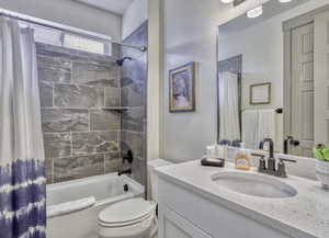 Bathroom featuring shower / bath combo and vanity