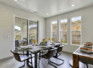Dining space featuring wood tiled floors and recessed lighting