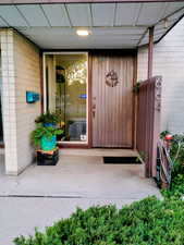 Property entrance featuring concrete block siding