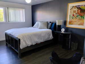 Bedroom featuring dark wood finished floors and a ceiling fan