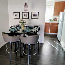 Dining area featuring dark wood-style floors
