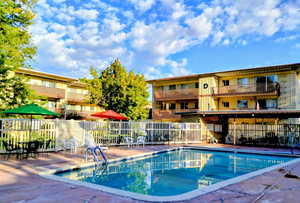Community pool with a patio
