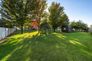 Fenced backyard with a storage unit