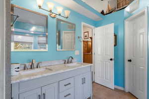 Bathroom featuring double vanity and light tile patterned floors