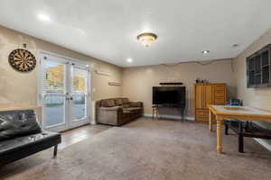 Living room featuring light carpet, recessed lighting, light tile patterned flooring, and french doors