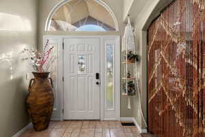 Foyer featuring tile patterned flooring and baseboards