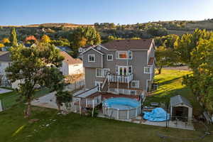 Back of property featuring a patio area, an outdoor pool, a fenced backyard, and stairway