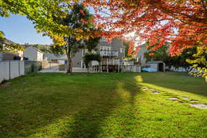 Fenced backyard with a balcony and a patio