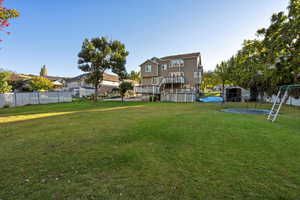 View of yard with stairway and a trampoline