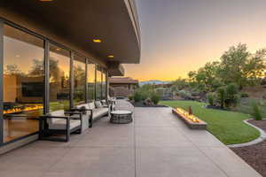 View of patio with an outdoor living space with a fire pit