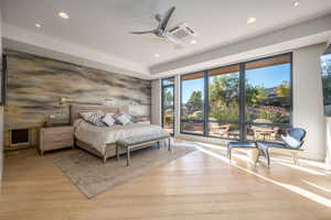 Bedroom featuring recessed lighting, an accent wall, light wood-type flooring, and ceiling fan