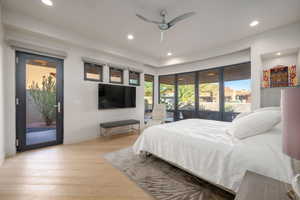 Bedroom with access to exterior, light wood-style flooring, recessed lighting, and a ceiling fan