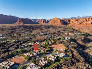 Aerial overview of property's location featuring a mountainous background and nearby suburban area