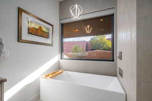 Full bath featuring a soaking tub