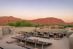 Patio terrace at dusk featuring a patio and a mountain view